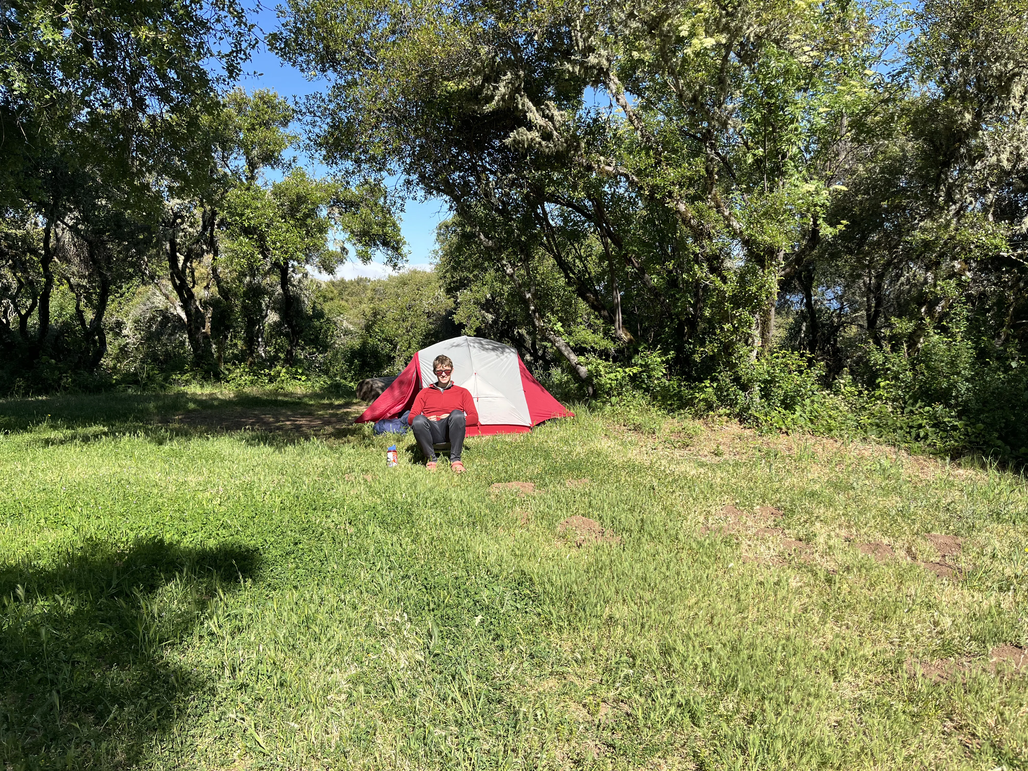 Campsite with Ben in chair in front